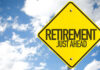 A yellow road sign indicating retirement is just ahead