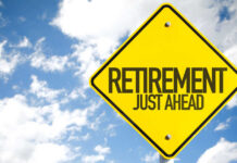 A yellow road sign indicating retirement is just ahead