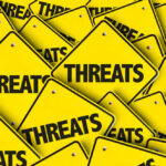Marjorie Taylor Greene Issues THIS Threat Yellow signs with the word threats overlapping