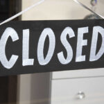 Shocking Beer Shutdown – 177-Year Icon Fades A black sign with the word 'CLOSED' painted in white letters