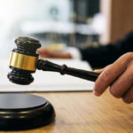 Federal Judge HALTS Voter Dragnet Gavel in judges hand about to strike.