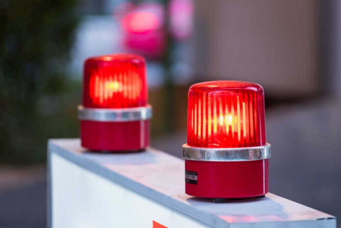 Siren,Red,Light,With,Soft-focus,In,The,Background red warning beacons on a barrier