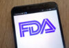 FDA’S HIGHEST ALERT: Popular Sauce Pulled Nationwide Close-up of a smartphone displaying the FDA logo