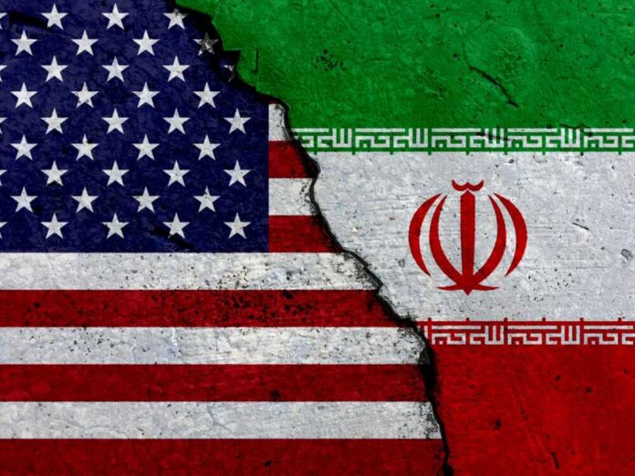 shutterstock_1607905798 A cracked surface displaying the flags of the USA and Iran