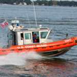 Mystery Grows: Coast Guard Bows Out?! U.S. Coast Guard boat speeding through water