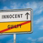 VIDEO: Not Guilty Verdict After Black Teen Killed A road sign displaying 'INNOCENT' with an arrow pointing up and 'GUILTY' crossed out