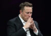 Elon Musk in suit thinking.