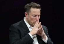 Musk Makes Mexican Immigrant a Millionaire Elon Musk in suit thinking.