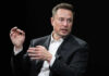 Elon Musk in a suit talking.