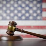 Supreme Court Shifts Border Power A wooden gavel resting on a sound block with an American flag background