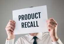 Vehicle Fire Alert – Park It Outside – 1 Million at Risk Person holding a sign reading product recall