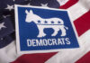 Democrats emblem on an American flag background.