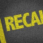 Moonroof Mayhem: 70,000 SUVs Recalled Yellow 'RECALL' text on a dark asphalt surface