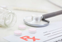 Mystery Gunk Triggers Massive Pill Recall A stethoscope, prescription pad, and pink tablets on a table
