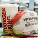 Nostalgia Playbook: Burger King’s Bold Bet A Whopper Jr. burger wrapped in paper next to a Burger King drink