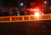 Ambush Chaos: 11-Year-Old Caught In Gunfire Crime scene tape with emergency vehicles in background.