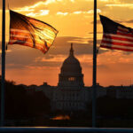 U.S. Senator Vanishes, Then Drops Bombshell Silhouetted American flags in front of the Capitol building during sunset