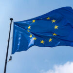 Europe Drops Hammer On Famed American Company European Union flag waving against a blue sky