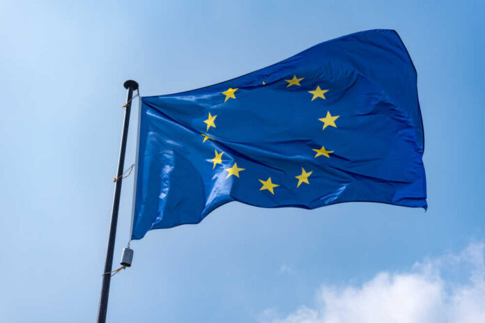 European Union flag waving against a blue sky