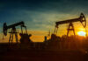 FBI-Style Oil Crackdown Looms Graphical representation of oil prices with oil pumps at sunset