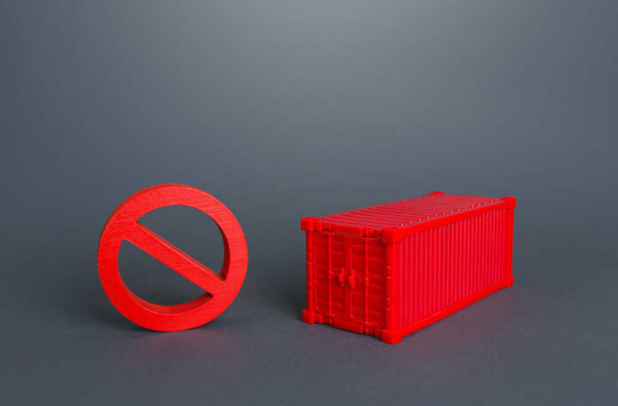Red,Container,And,No,Prohibition,Sign.,Logistic,Crisis,In,Cargo A red prohibition sign next to a red shipping container
