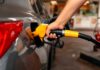 Price Shock Slams Pumps A person refueling a car at a gas station