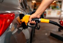 Price Shock Slams Pumps A person refueling a car at a gas station
