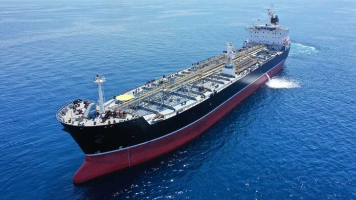 Aerial,Drone,Photo,Of,Crude,Oil,Tanker,Carrier,Anchored,In A large oil tanker sailing on calm ocean waters