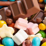 Candy Giant Ditches NJ — Why Now? Colorful candies and chocolate bar close-up.