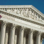 U.S. Supreme Court building with American flag.