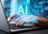 AI Bonfire, Human Jobs Vanish Person typing on laptop with AI hologram