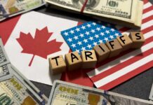 Tariff Smoke Bomb — Trump Targets Canada A view of stacked shipping containers at a port with a bridge in the background
