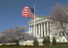 Ballots Blocked? Supreme Court Holds The Key U.S. Supreme Court building with an American flag and cherry blossom trees