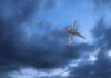 Airline Cabin Odor Forces Atlantic Detour An airplane flying through a cloudy sky