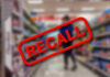 Border Fail Triggers Massive Recall Recall stamp on blurred store aisle background.
