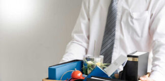 Person holding a box of personal office items.