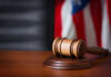 Defying Judge, Kennedy Center Gambles Big A wooden gavel resting on a sound block with an American flag in the background