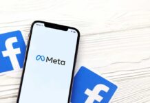 Meta’s $18B Surrender: What’s Hidden? Phone displaying Facebook app in a car