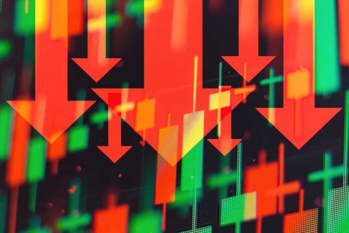 Red downward arrows over red and green stock candlestick chart