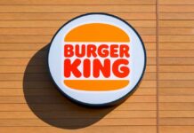 Burger King Overtakes Wendy’s — What Really Changed? Burger King logo displayed on a wooden wall