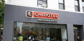 Chipotle Mexican Grill restaurant exterior with people inside.