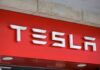 Tesla’s Meltdown: 2.98M Cars Recalled Tesla logo displayed on a red background