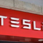 Tesla’s Meltdown: 2.98M Cars Recalled Tesla logo displayed on a red background