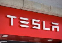 Tesla’s Meltdown: 2.98M Cars Recalled Tesla logo displayed on a red background