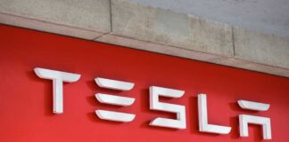 Tesla logo displayed on a red background