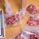 Deli Meat Recall Sparks Listeria Scare Hands wearing gloves vacuum sealing meat in plastic bags