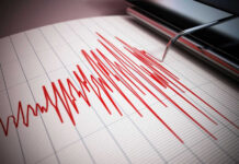 Seismograph recording earthquake activity in red.