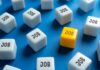 Payrolls Slide — Revisions Make It Worse A yellow cube with the word 'JOB' surrounded by white cubes with the same word on a blue background