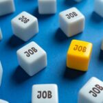 Payrolls Slide — Revisions Make It Worse A yellow cube with the word 'JOB' surrounded by white cubes with the same word on a blue background