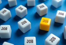 Payrolls Slide — Revisions Make It Worse A yellow cube with the word 'JOB' surrounded by white cubes with the same word on a blue background